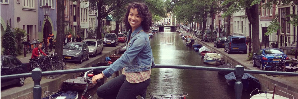Providence College student biking in Amsterdam