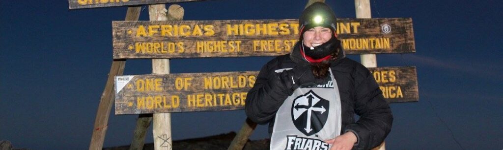 a student standing on Mt. Kilimanjaro