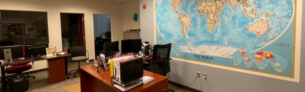 a classroom with a world map hanging up